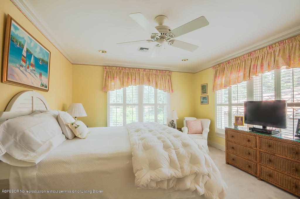 282 Barcelona Road West Palm Beach, FL 33401 - Photo 14 of 32 a bedroom with a bed and a flat screen tv