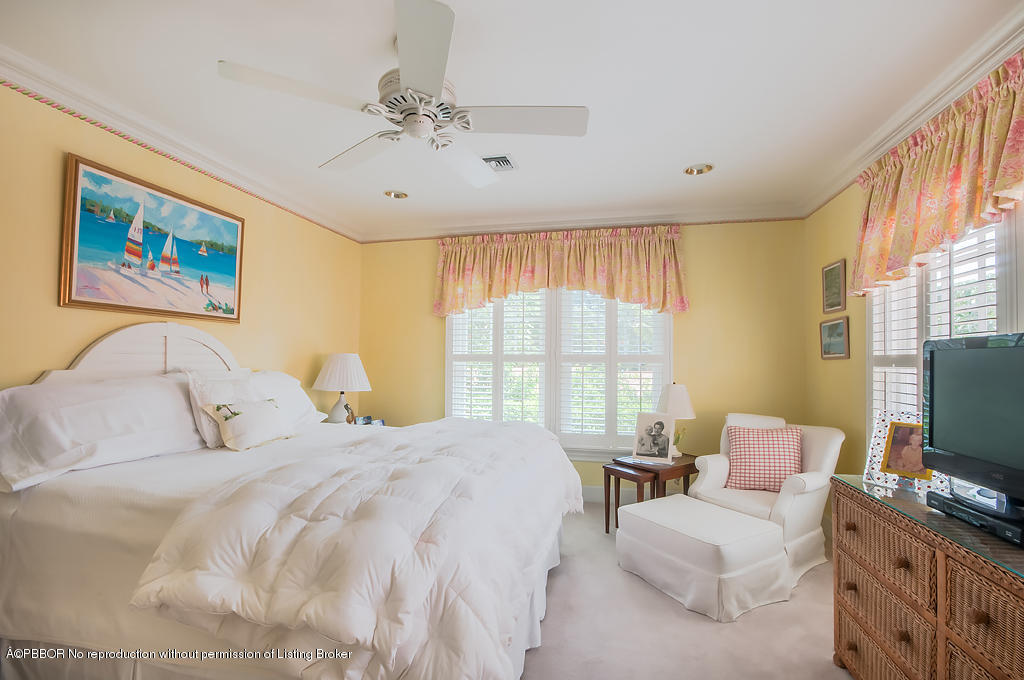 282 Barcelona Road West Palm Beach, FL 33401 - Photo 16 of 32 a bedroom with a bed and a flat screen tv