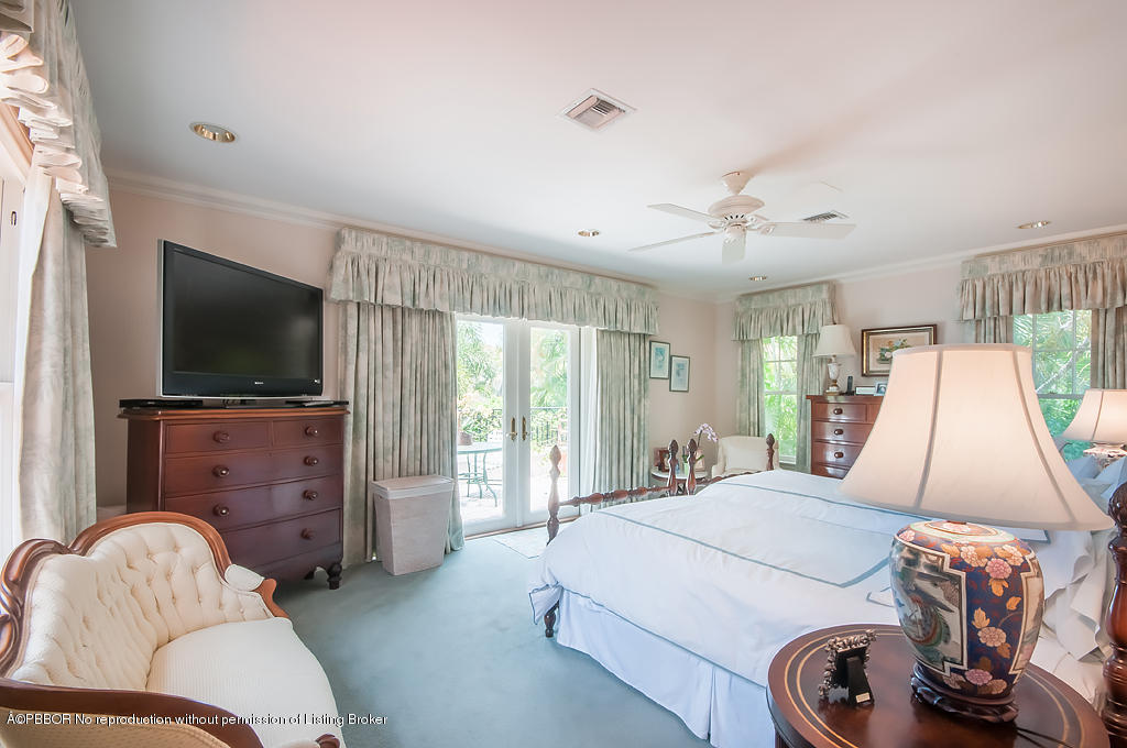 282 Barcelona Road West Palm Beach, FL 33401 - Photo 17 of 32 a bedroom with a bed and a flat screen tv