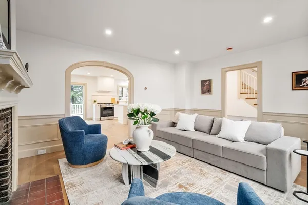 a living room with furniture potted plant and a window