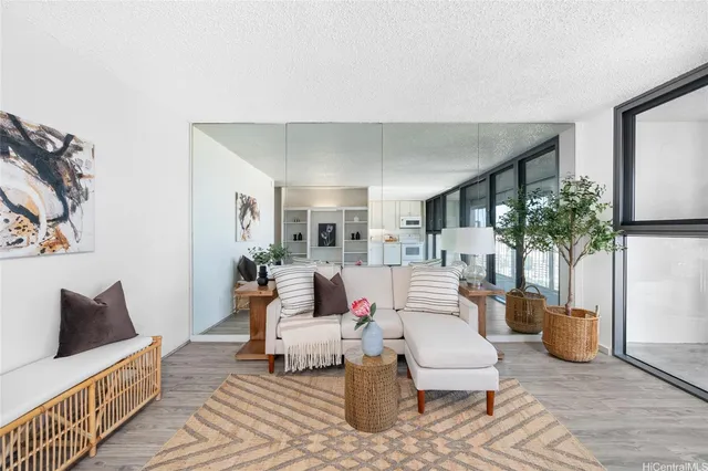 a living room with furniture and a potted plant