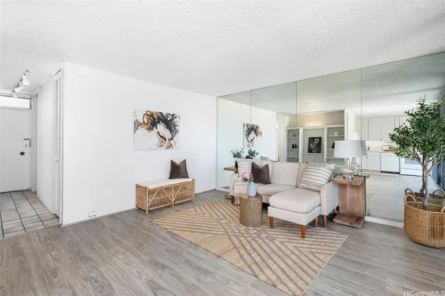 a living room with furniture and wooden floor