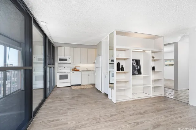 a view of kitchen with wooden floor and electronic appliances