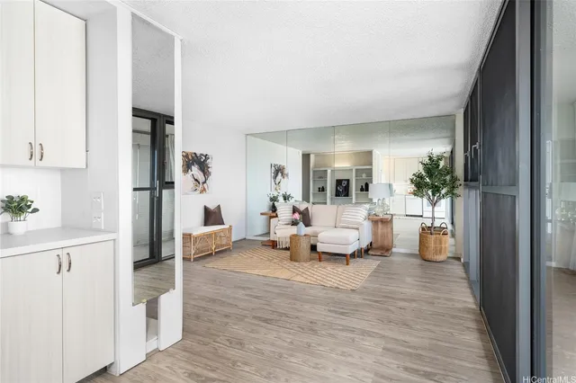 a living room with furniture and a wooden floor