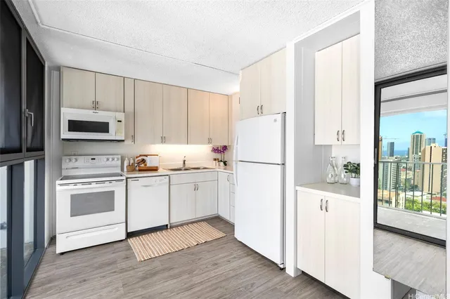 a kitchen with white cabinets and white appliances
