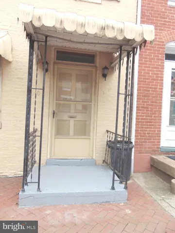 a view of wooden door and outdoor seating