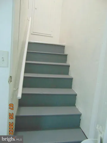 a view of a hallway with wooden floor and entryway