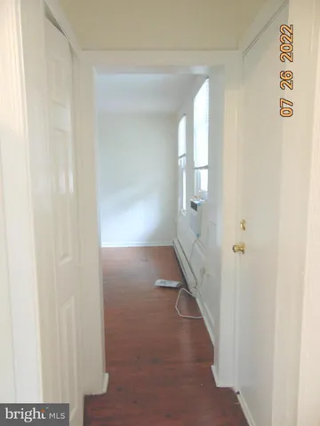 a view of a room with wooden floor and window