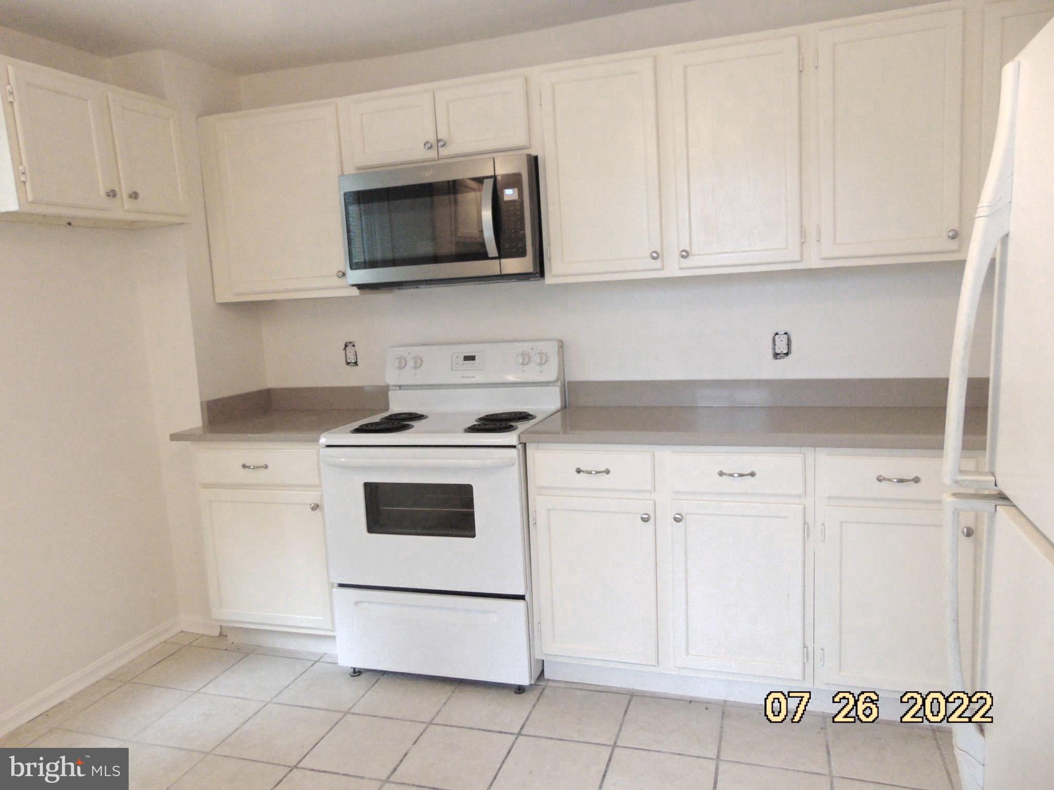 140 West South Street Frederick, MD 21701 - Photo 25 of 33 a kitchen with white cabinets and stainless steel appliances