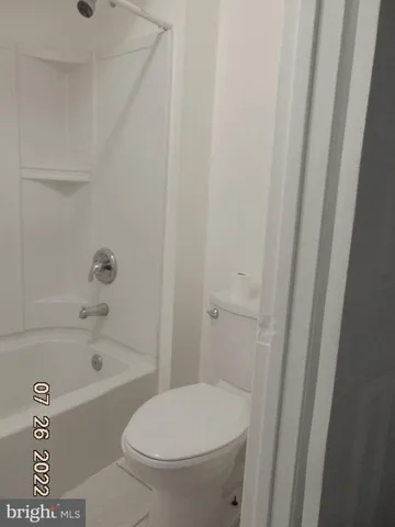a bathroom with a toilet and a bathtub