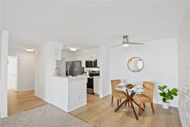 a kitchen with stainless steel appliances a stove microwave and refrigerator