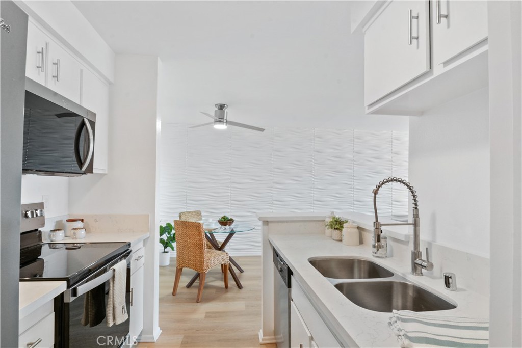 28121 Highridge Road, Unit 402 Rancho Palos Verdes, CA 90275 - Photo 16 of 39 a kitchen with a sink cabinets and appliances