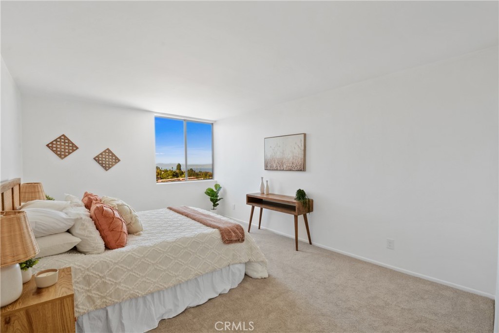 28121 Highridge Road, Unit 402 Rancho Palos Verdes, CA 90275 - Photo 16 of 38 a bedroom with a bed and a painting on the wall