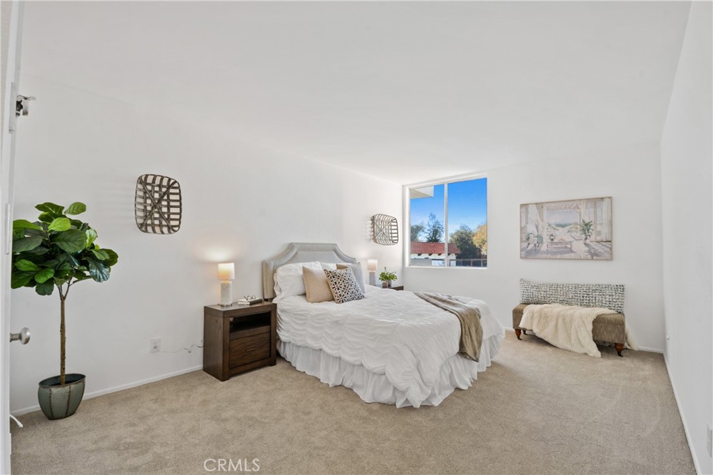 28121 Highridge Road, Unit 402 Rancho Palos Verdes, CA 90275 - Photo 20 of 38 a bedroom with bed and a potted plant