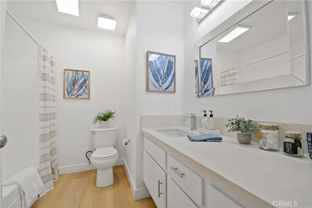 28121 Highridge Road, Unit 402 Rancho Palos Verdes, CA 90275 - Photo 24 of 38 a bathroom with a granite countertop toilet sink and a mirror