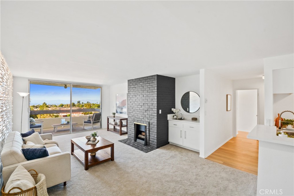 28121 Highridge Road, Unit 402 Rancho Palos Verdes, CA 90275 - Photo 6 of 39 a living room with furniture and a fireplace