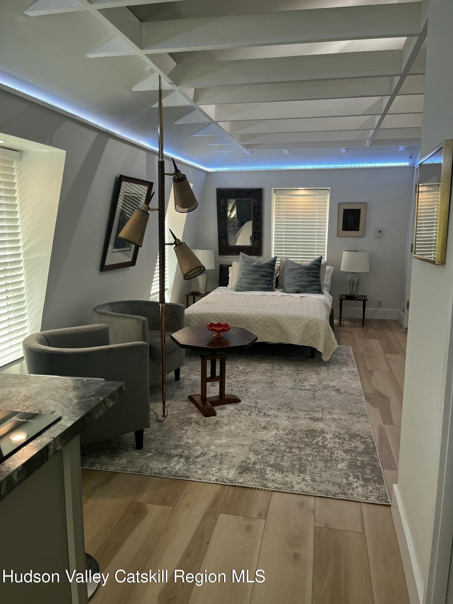 20 Tannery Brook Road, Unit 6 Woodstock, NY 12498 - Photo 2 of 12 a living room with furniture a flat screen tv and rug