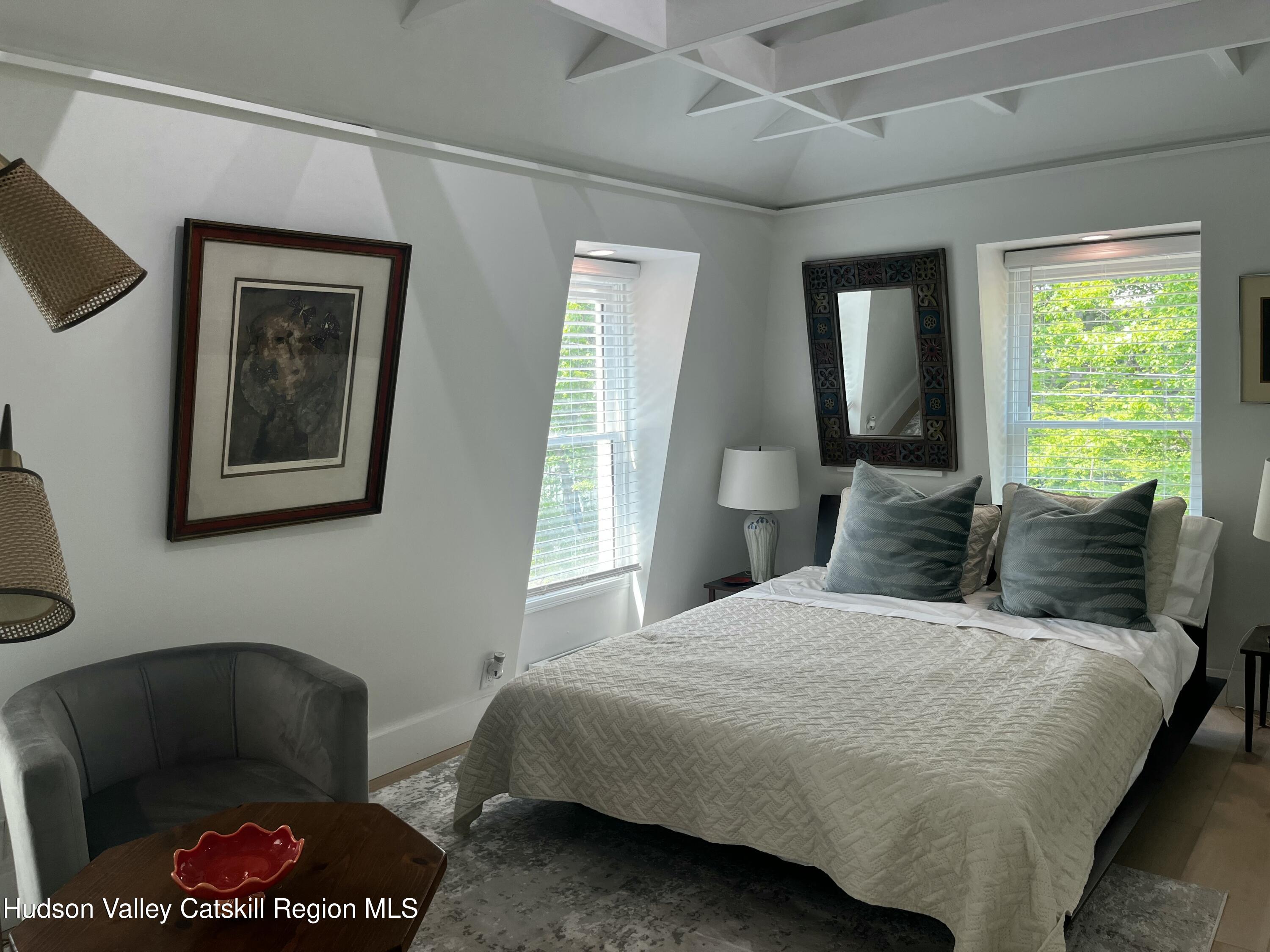 20 Tannery Brook Road, Unit 6 Woodstock, NY 12498 - Photo 3 of 12 a bedroom with a bed and a chair