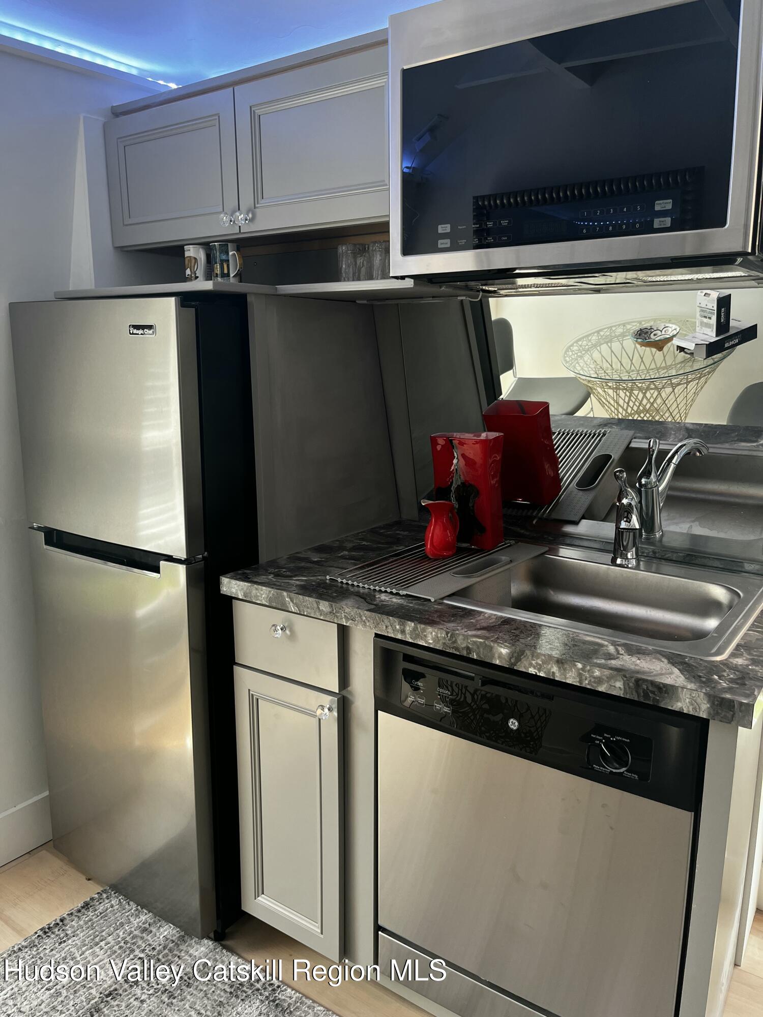 20 Tannery Brook Road, Unit 6 Woodstock, NY 12498 - Photo 6 of 12 a kitchen with granite countertop a refrigerator and a stove