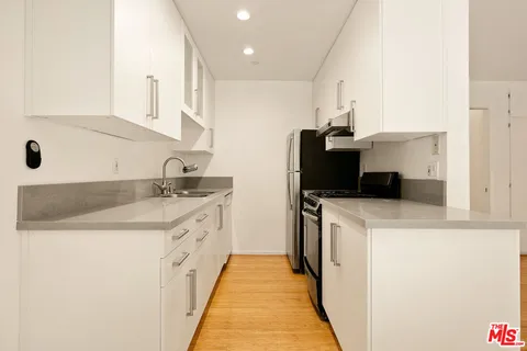 a kitchen with a sink and a stove top oven