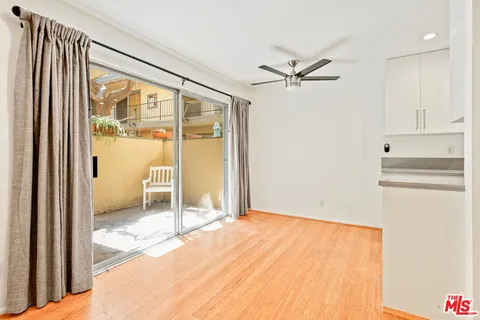 a view of a livingroom with a ceiling fan and window