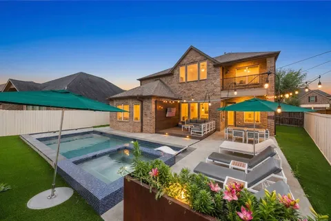 swimming pool view with a seating space