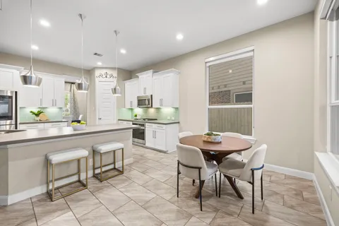 a large kitchen with granite countertop lots of counter space and stainless steel appliances