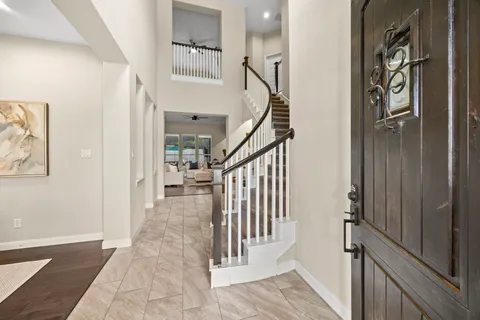 a view of entryway and hall with wooden floor