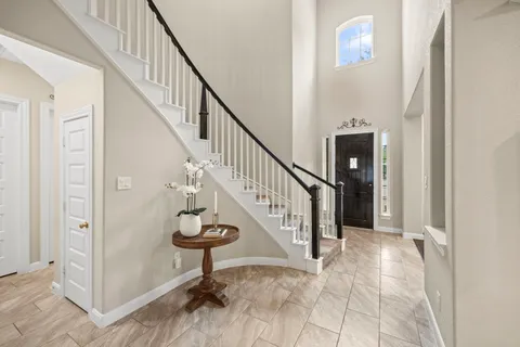 a view of staircase with wooden floor and a rug