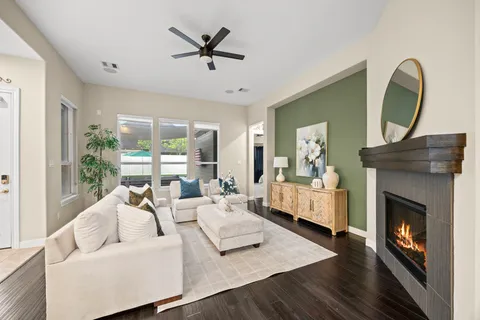 a living room with furniture fireplace and a large window