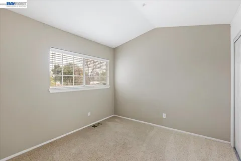 a view of a backyard with wooden fence