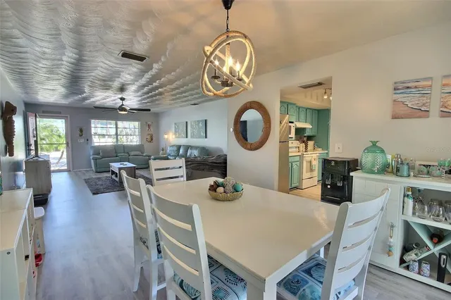 a view of a dining room with furniture and a clock
