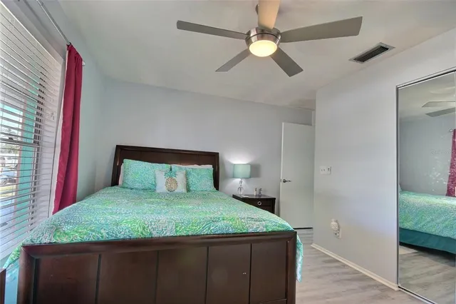 a bedroom with a large bed and a chandelier