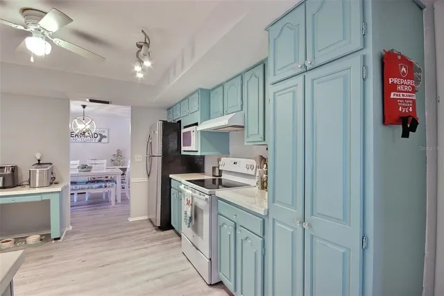a kitchen with furniture a counter space cabinets and appliances