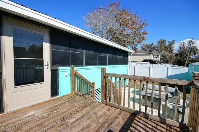 a balcony with wooden floor and fence