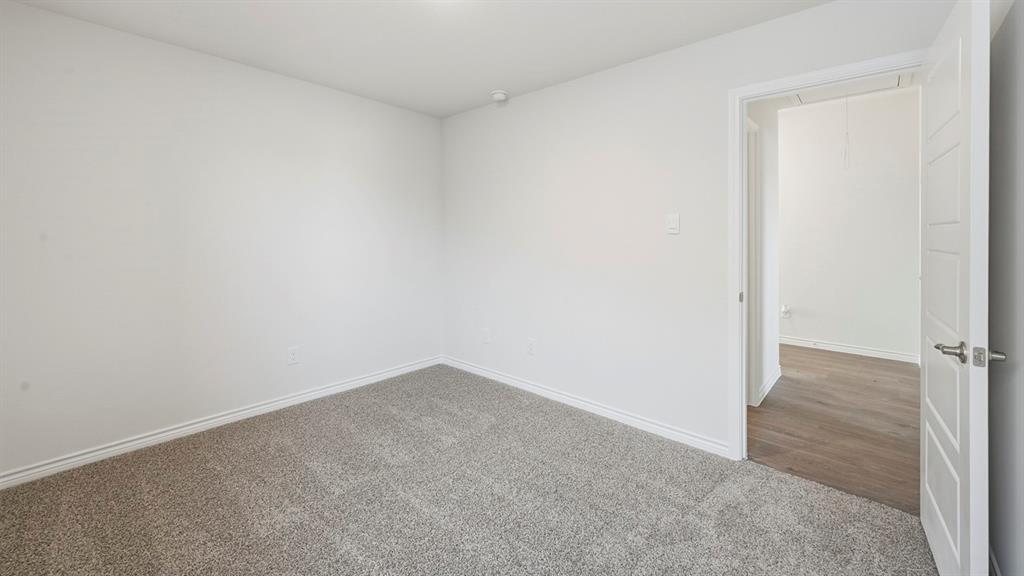419 Epiphany Lane Lavon, TX 75166 - Photo 27 of 31 Neutral-toned carpet flooring and white baseboards