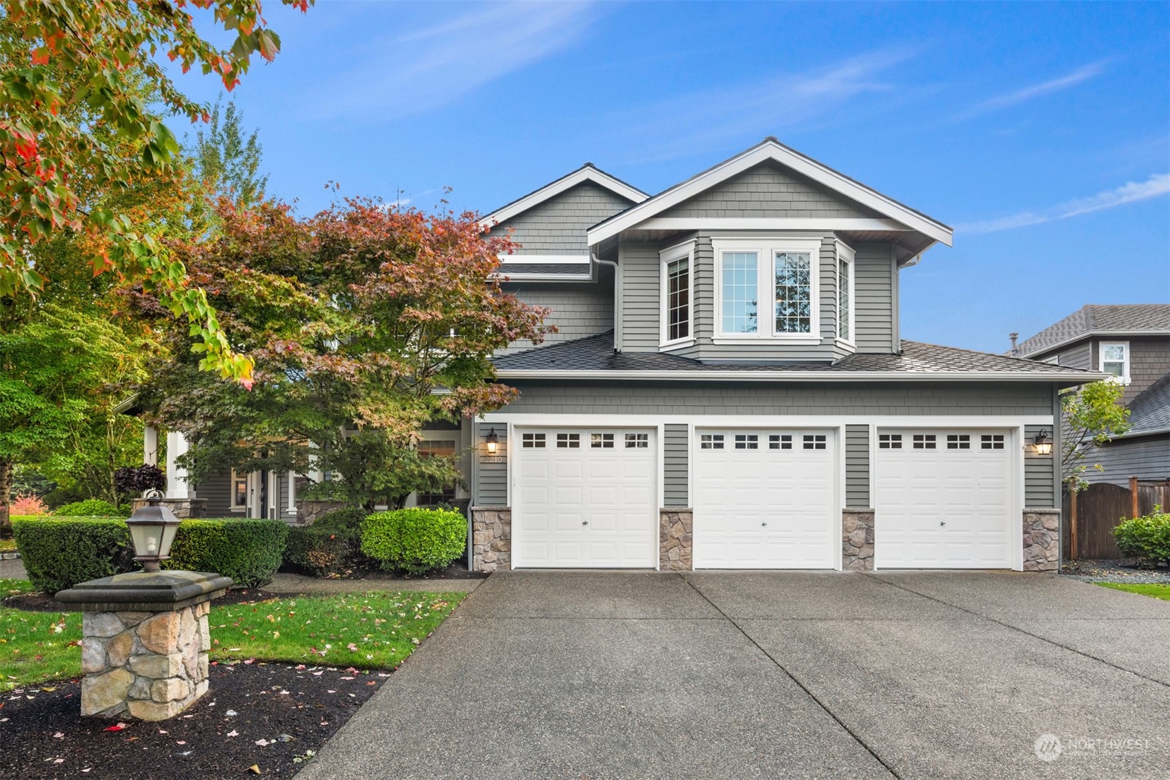 2210 242nd Street Southeast Bothell, WA 98021 - Photo 27 of 40 a view of a white house with a small yard and a large tree