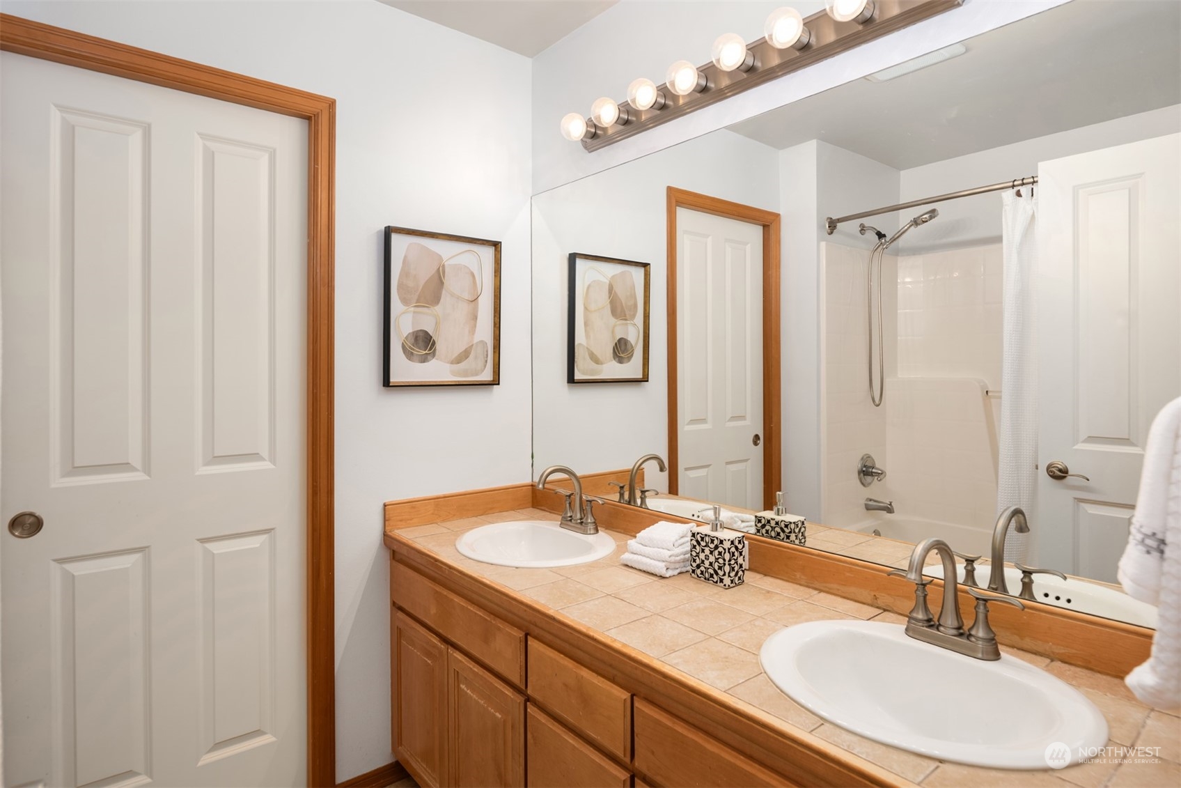 2210 242nd Street Southeast Bothell, WA 98021 - Photo 37 of 40 a bathroom with double vanity sinks a mirror and a shower