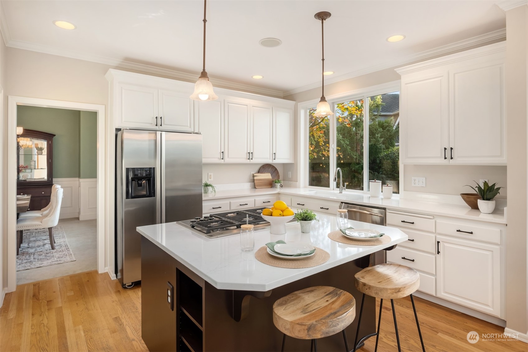 2210 242nd Street Southeast Bothell, WA 98021 - Photo 40 of 40 a kitchen with a refrigerator a stove a sink and a dining table with chairs