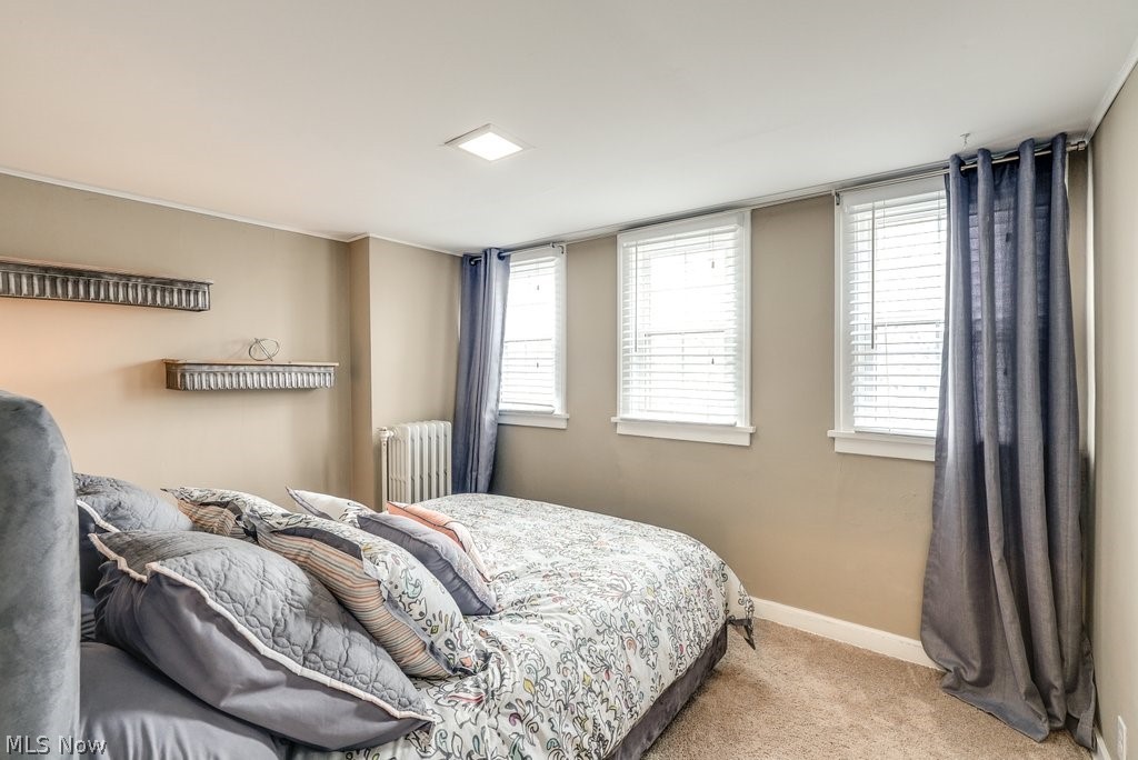 16010 Fernway Road Cleveland, OH 44120 - Photo 23 of 30 Bedroom featuring radiator, multiple windows, and light carpet