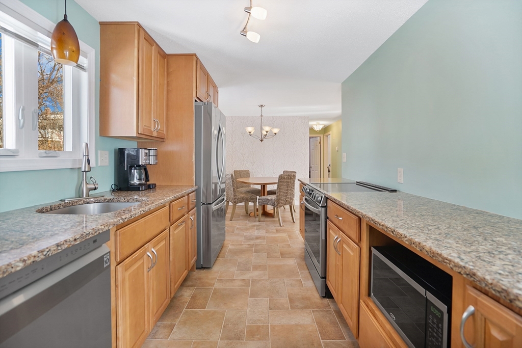 72 Gail Street Springfield, MA 01108 - Photo 14 of 35 a kitchen with stainless steel appliances granite countertop a sink counter space cabinets and a large window