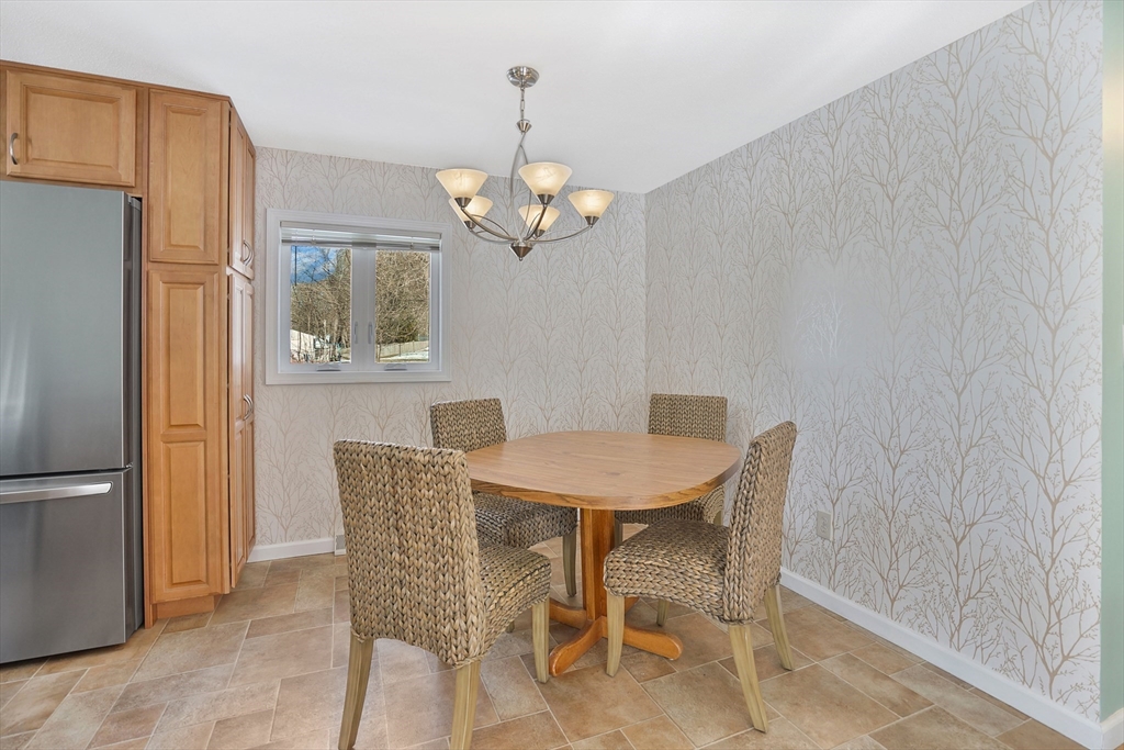 72 Gail Street Springfield, MA 01108 - Photo 19 of 35 a view of a dining room with furniture a chandelier and wooden floor