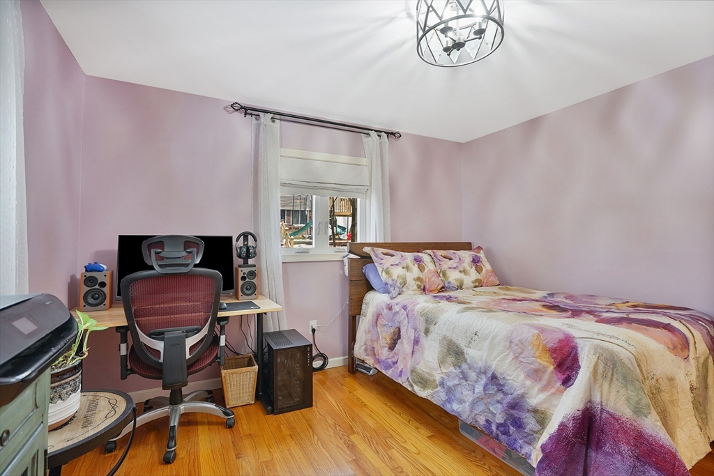 72 Gail Street Springfield, MA 01108 - Photo 27 of 35 a bedroom with a bed and a chair with the wooden floor