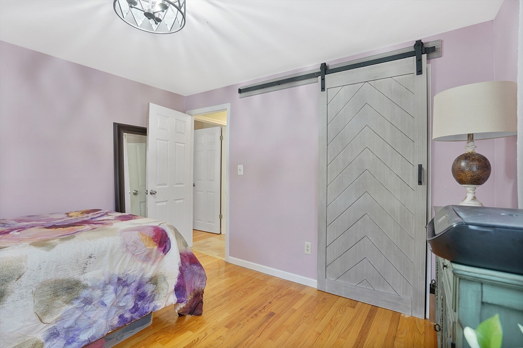 72 Gail Street Springfield, MA 01108 - Photo 28 of 35 a bedroom with a bed and a mirror