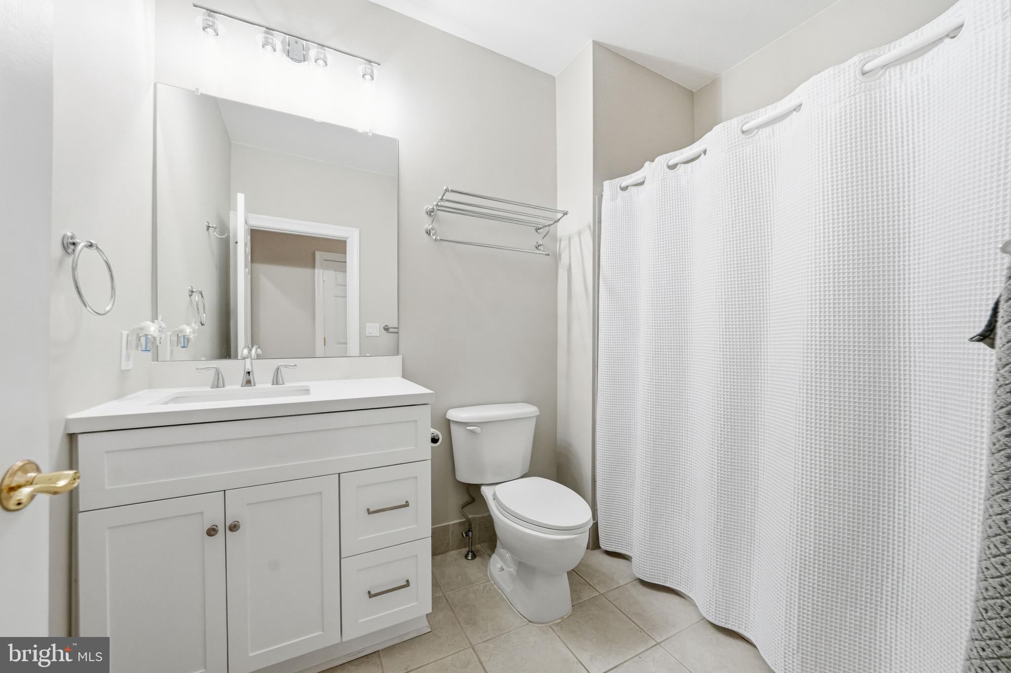 204 Bobwhite Road New Hope, PA 18938 - Photo 14 of 22 a bathroom with a sink a toilet and a mirror