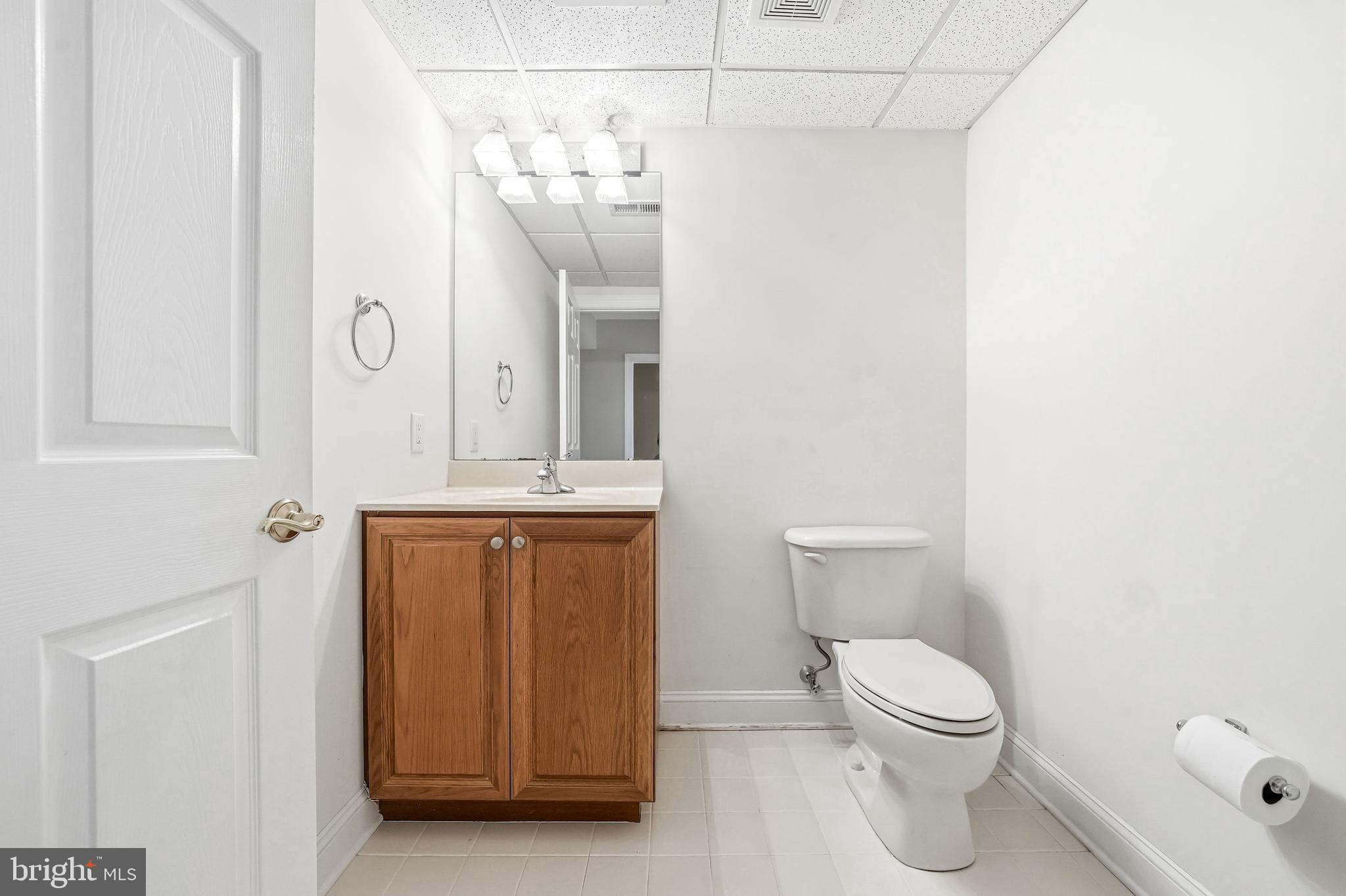 204 Bobwhite Road New Hope, PA 18938 - Photo 19 of 22 a bathroom with a toilet a sink a mirror and vanity