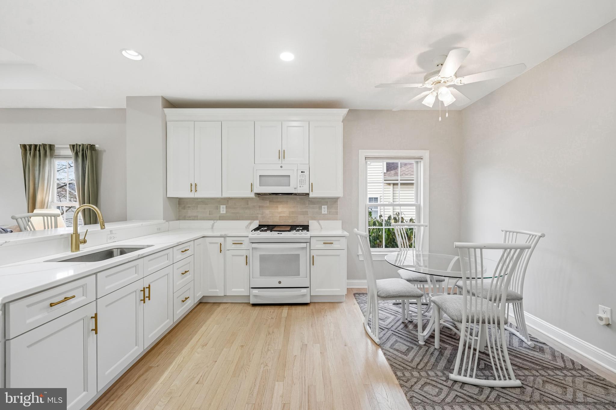 204 Bobwhite Road New Hope, PA 18938 - Photo 3 of 22 a kitchen with a sink dishwasher a stove a dining table and chairs