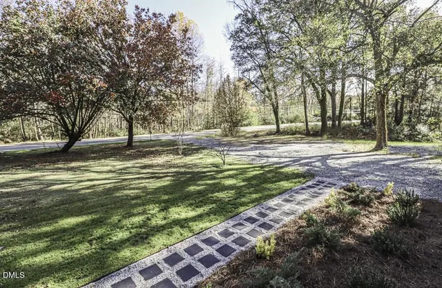a view of a yard with large trees