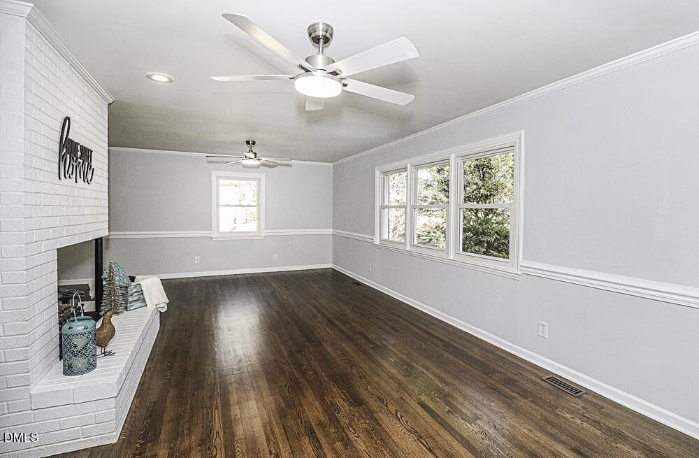 805 River Road Selma, NC 27576 - Photo 16 of 40 a view of an empty room with wooden floor and a window