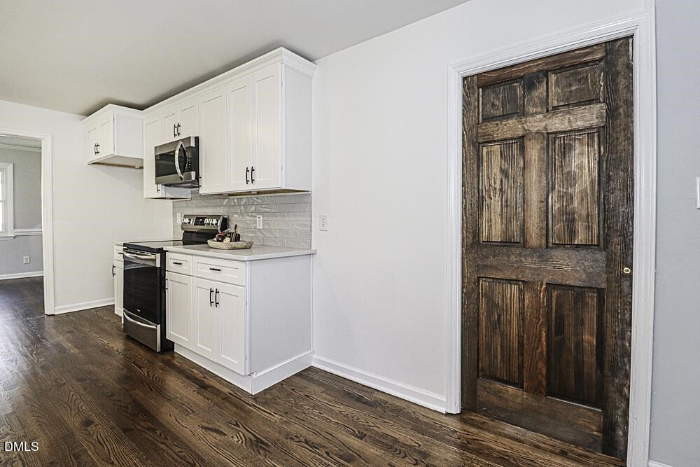 805 River Road Selma, NC 27576 - Photo 19 of 40 a kitchen with stainless steel appliances granite countertop a stove and a refrigerator